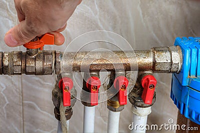 Human hand turn off shut-off valve home water supply. Stock Photo