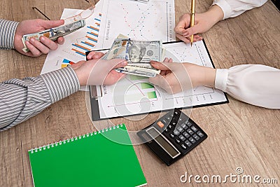 Human hands exchanging money above business graph Stock Photo