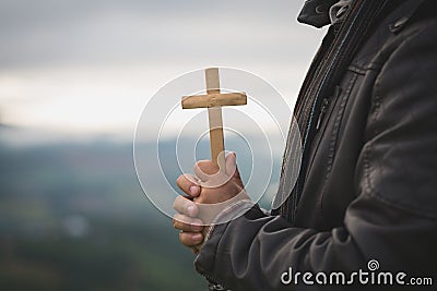 Human hands holding a cross holy and prayed for blessings from God, Amour Worship God concept. - Image Stock Photo