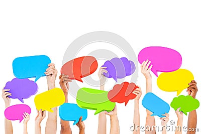 Human hands holding multi colored speech bubbles Stock Photo