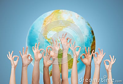 Human hands showing ok sign over earth globe Stock Photo