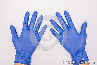 Human hands wearing blue surgical latex nitrile gloves for doctor and nurse protection during patient examination on white Stock Photo