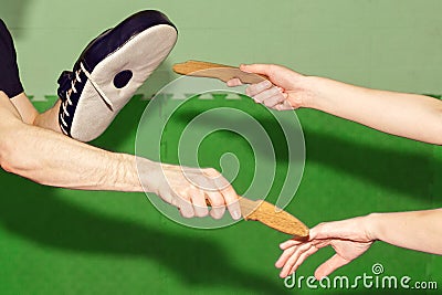 Human hands with wooden knives during training Stock Photo