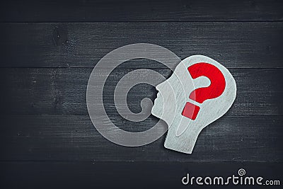 Human head and face with red question mark sign on wood table background. Brain of thinking about problem solving , Symbol of Stock Photo