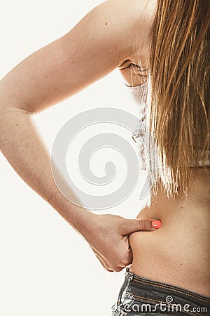 Human holding pinching fat body hip. Stock Photo