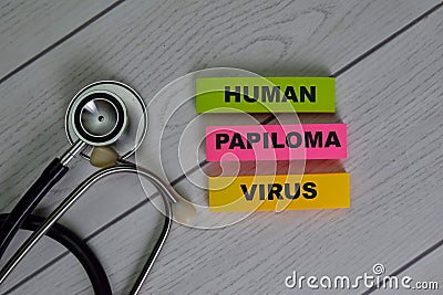 Human Papiloma Virus write on sticky notes isolated on Wooden Table Stock Photo