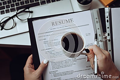 Human resource manager reading CV resumes of job candidate. Stock Photo