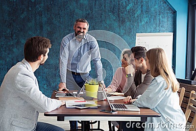 Human resource manager training people about company and future prospects. Group of businesspeople sitting in meeting Stock Photo