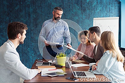 Human resource manager training people about company and future prospects. Group of businesspeople sitting in meeting Stock Photo