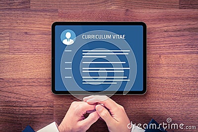 Human resources recruiter read resume on digital tablet Stock Photo