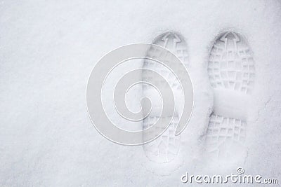 Human`s footprint on a first white snow, top view Stock Photo