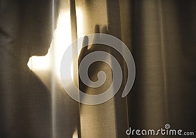 Human shadow behind a curtain Stock Photo