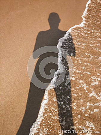 Human shadow on the sand Stock Photo