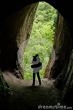 Human silhouette in the cave - Haiducilor Grotto, Baile Herculane, landmark attraction in Romania Stock Photo