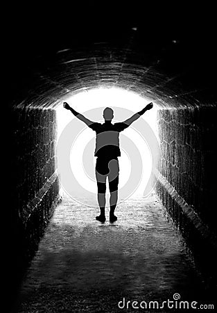 Human silhouette in tunnel exit Stock Photo