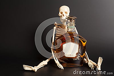 Human skeleton with cognac, brandy bottle Stock Photo