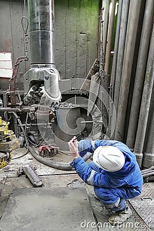 Human work while drilling an oil and gas well. Editorial Stock Photo