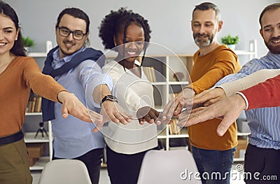 Group of diverse multiethnic people joining hands together front view shot Stock Photo