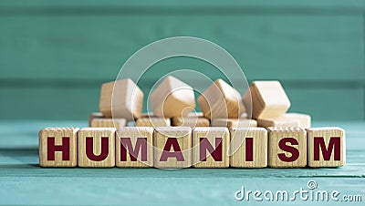 HUMANISM - word on wooden cubes on a green background with lavender Stock Photo