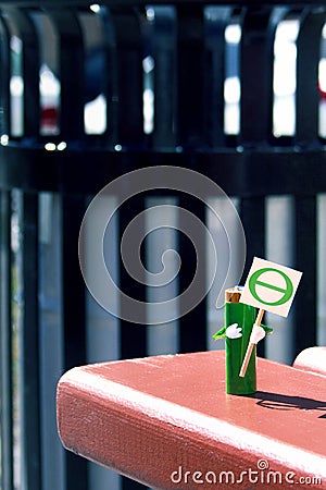 Humanized figure made of AA battery holds in hands poster with the theta symbol of the earth day. Holiday concept. Copy space for Stock Photo