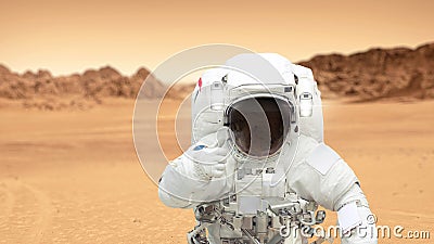 Humans on the planet Mars. Astronaut on Mars shows a thumbs-up Stock Photo