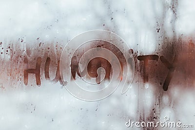 Humidity word written on wet window. High level of dampness in apartment Stock Photo