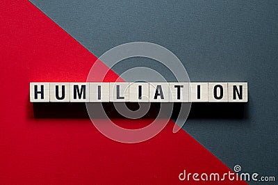 Humiliation word concept on cubes Stock Photo