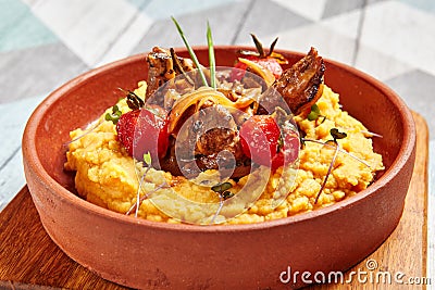 Hummus with beef served in brown bowl Stock Photo