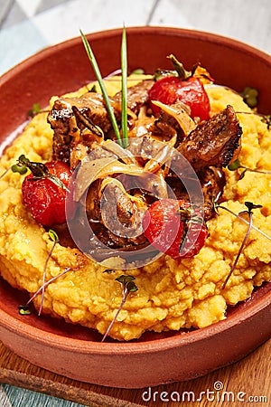 Hummus with beef served in brown bowl Stock Photo