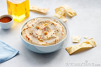 Hummus bowl with chips, chickpeas, and olive oil Stock Photo