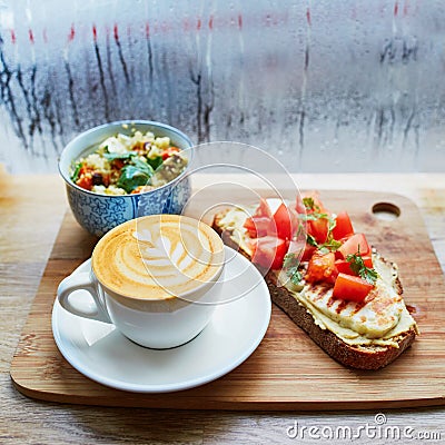 Hummus and tomato sandwich, salad and fresh hot cappuccino coffee Stock Photo