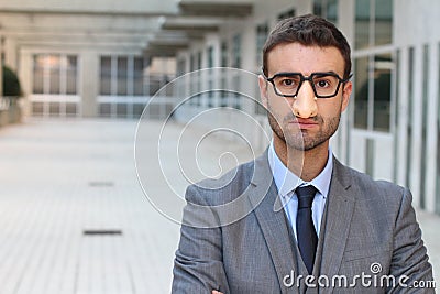 Humorous businessman wearing a disguise Stock Photo