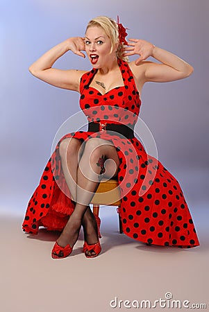 Humorous pinup girl in red dress with tattoo Stock Photo