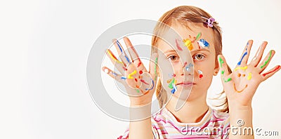 Humorous portrait of little cute girl with children`s makeup and painting colorful hands Stock Photo