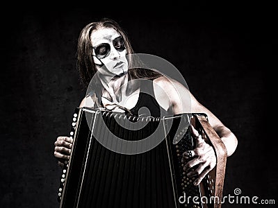 Humorous portrait of man in goth style clothes and scull makeup. Stock Photo