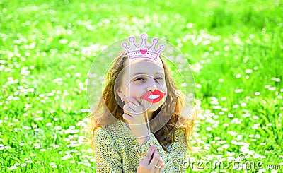 Humour queen concept. Girl sits on grass at grassplot, green background. Girl on cheerful face spend leisure outdoors Stock Photo