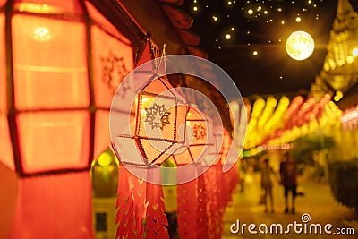Hundred Thousand Lantern Festival in Lamphun people hang colorful light lanterns at Wat Phra That Hariphunchai Temple Stock Photo
