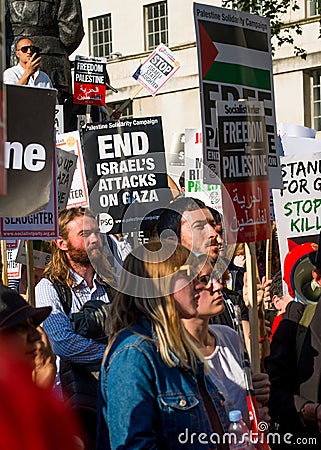 Protesters with placards at the Gaza: Stop The Massacre rally in Whitehall, London, UK. Editorial Stock Photo