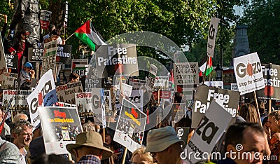Protest messages on placards and posters at the Gaza: Stop The Massacre rally in Whitehall, London, UK. Editorial Stock Photo