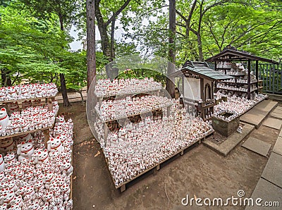 Hundreds or thousands of Japanese manekineko cat in the gotokuji zen temple. Editorial Stock Photo