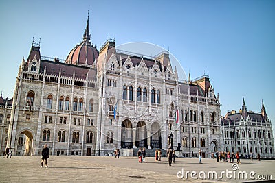 The Hungarian paliament building with walking people around square, Budapest. Editorial Stock Photo