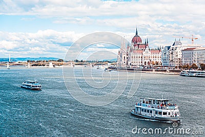 The Hungarian Parliament builded on the riverside of the Danube, on which the ship sails. Editorial Stock Photo