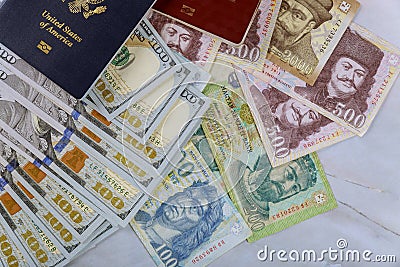 The Hungarian passports and American passport with money banknotes american hundred dollar bills and forints in dual citizenship Stock Photo