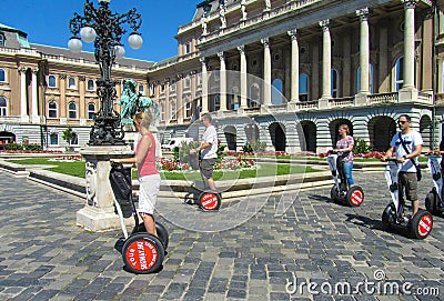 Hungary, Budapest, August 29, 2015. Royal Palace. Tourists travel by hoverboard Editorial Stock Photo