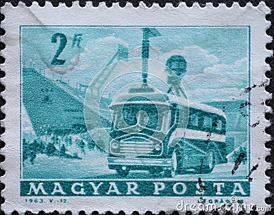 Hungary circa 1963: A post stamp printed in Hungary showing a bus with transmitters. Mobile Radio Transmitter and Stadium Editorial Stock Photo