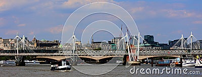 The Hungerford Bridge crosses the River Thames Editorial Stock Photo