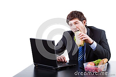 Hungry businessman eating a sadwich Stock Photo