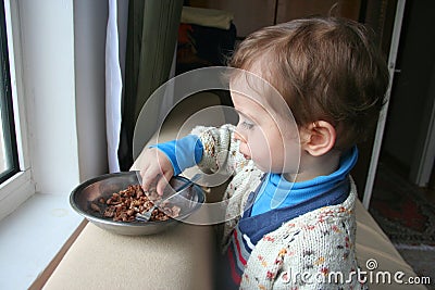 Hungry child eating meat Stock Photo