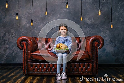 Hungry child with tasty fried chicken in the hand Stock Photo