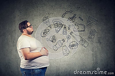 Hungry fat man thinking of junk food Stock Photo